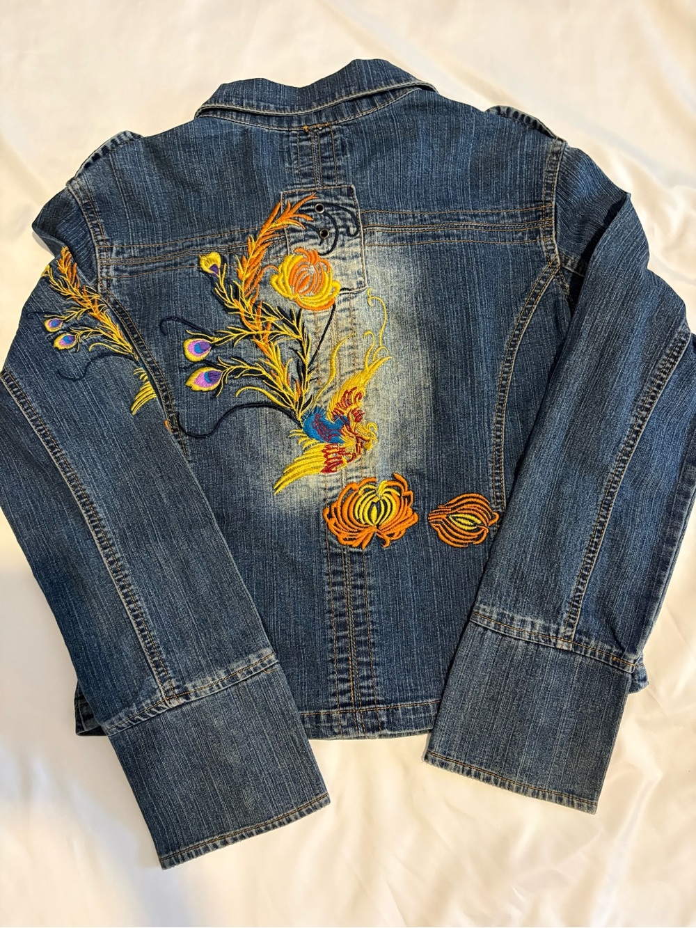 “Vintage-inspired Rosy Loves embroidered denim jacket with a timeless boho look.